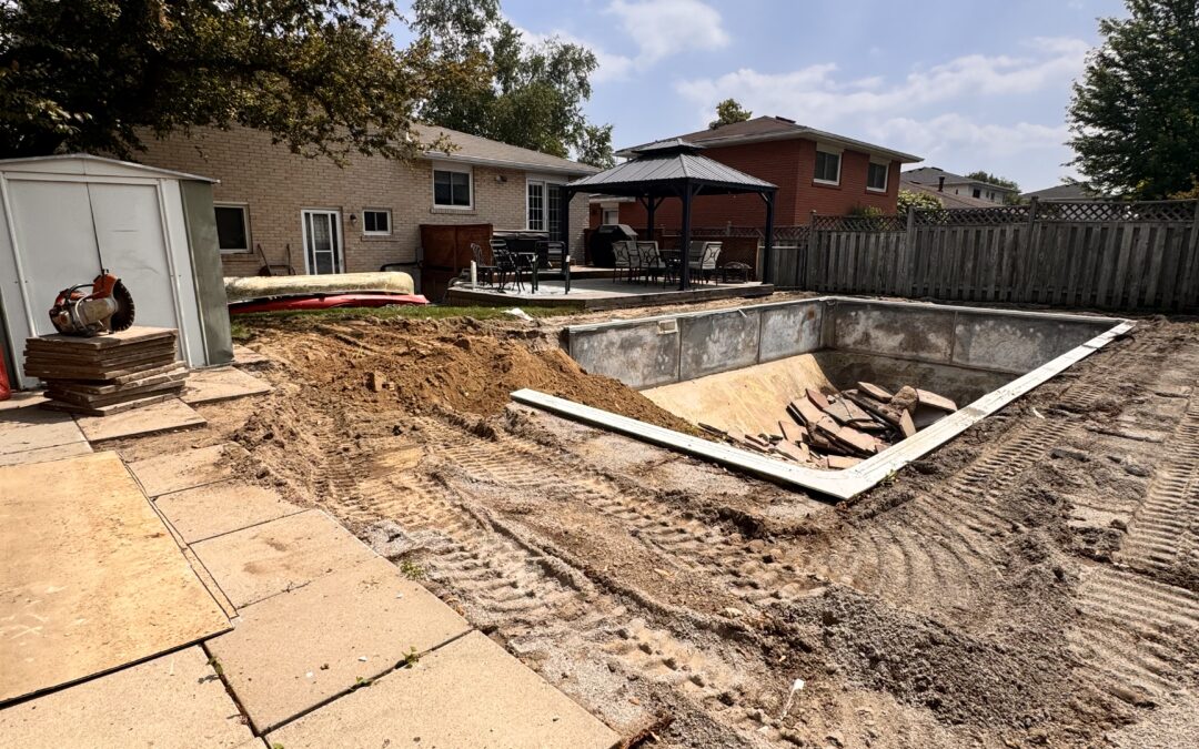 Concrete slabs being removed from around an exterior pool